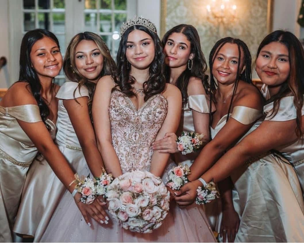 Birthday girl and her court in champagne gowns with matching blush rose bouquets and wrist corsages
